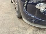 a close up of a car ' s front bumper and tire