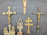 a lot of crosses and other religious items on a table