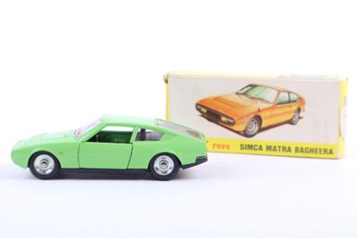 an image of a green toy car next to a box of matches