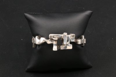 un gros plan d'une bague posée sur un coussin, sur une surface noire