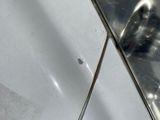 a close up of a sink with a mirror on the wall