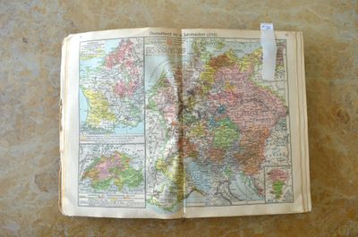 an open book with a map on it on a table