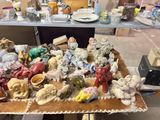 a lot of figurines sitting on a table in a room