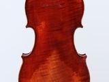 an old violin hanging from a string on a white background