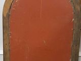 an old wooden arched window with a red painted door