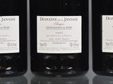 three bottles of wine sitting on top of a table next to each other