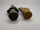 pair of antique brass door knobs on a white surface
