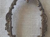 an old metal frame with a red string hanging from it