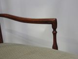 an image of a wooden chair with a beige upholstered seat
