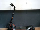 an electric scooter parked against a wall in a garage