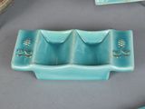 a blue tray with three compartments and a knife on a table