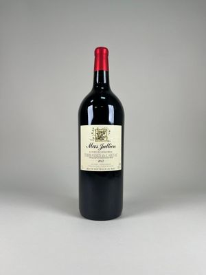 the bottle of red wine is sitting on the table