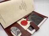 leather wallet with a wax seal and a wax stamp on it