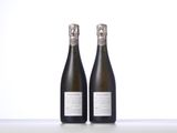 two bottles of champagne sitting on top of a table