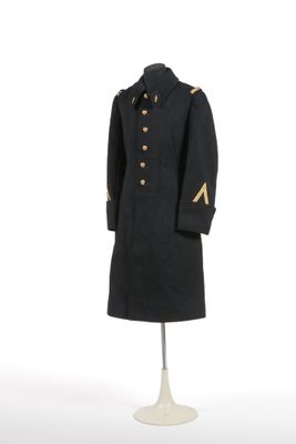 an image of a black coat with gold buttons on a mannequin stand