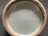 an image of a close up of a vase with a tag on it