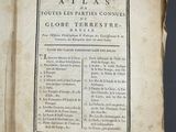 an old book with a page of text on it sitting on top of a table