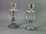 pair of clear glass candlesticks on a grey background