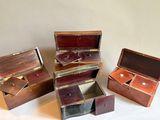 three small wooden boxes sitting next to each other on a white surface