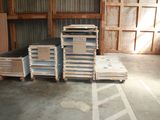 several stacks of pallets are stacked up in a warehouse