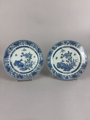 two blue and white plates with flowers and birds on them