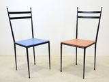 two chairs sitting next to each other in a room