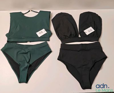 two pieces of swimsuits on a table with tags on them
