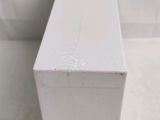 a white box sitting on the floor next to a toilet