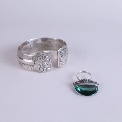 sterling silver ring with a green stone and a silver ring with a green stone