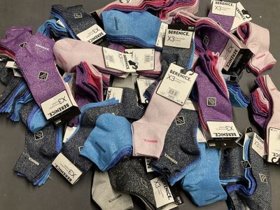 a pile of socks with tags on them on a table