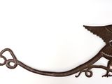 a metal bird that is hanging on the wall