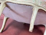 a chair that is sitting on a pink surface