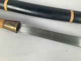 two different types of knives on a white surface