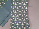 a tie that is laying on a table next to a pair of pants