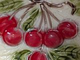 a close up of a plate with cherries on it