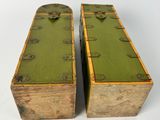 pair of green painted wooden boxes with metal handles on a white background