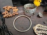 a wooden table with a bunch of jewelry on it
