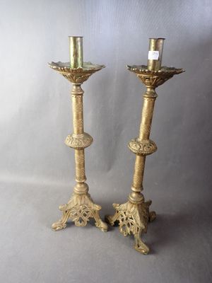 pair of antique brass candlesticks with ornate designs