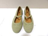 pair of women ' s green shoes on a white surface