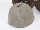a helmet sitting on a table next to a bowl