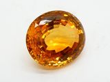 gros plan d'une pierre de saphir jaune sur une surface blanche