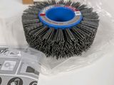 a close up of a cup brush on a table next to a package
