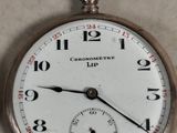 a close up of a pocket watch on a table