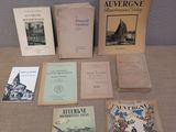 several books are sitting on a table in front of a wall