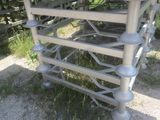 a metal table that has a bunch of chairs on it