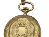 gold plated pocket watch with a medallion design on the face