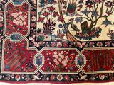 a large oriental rug with birds and flowers on it