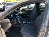 the interior of a car with the door open and the driver ' s seat down