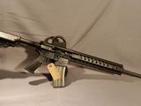 the rifle is sitting on a white sheet and ready to be used