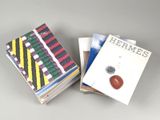 two books are stacked on top of each other on a table